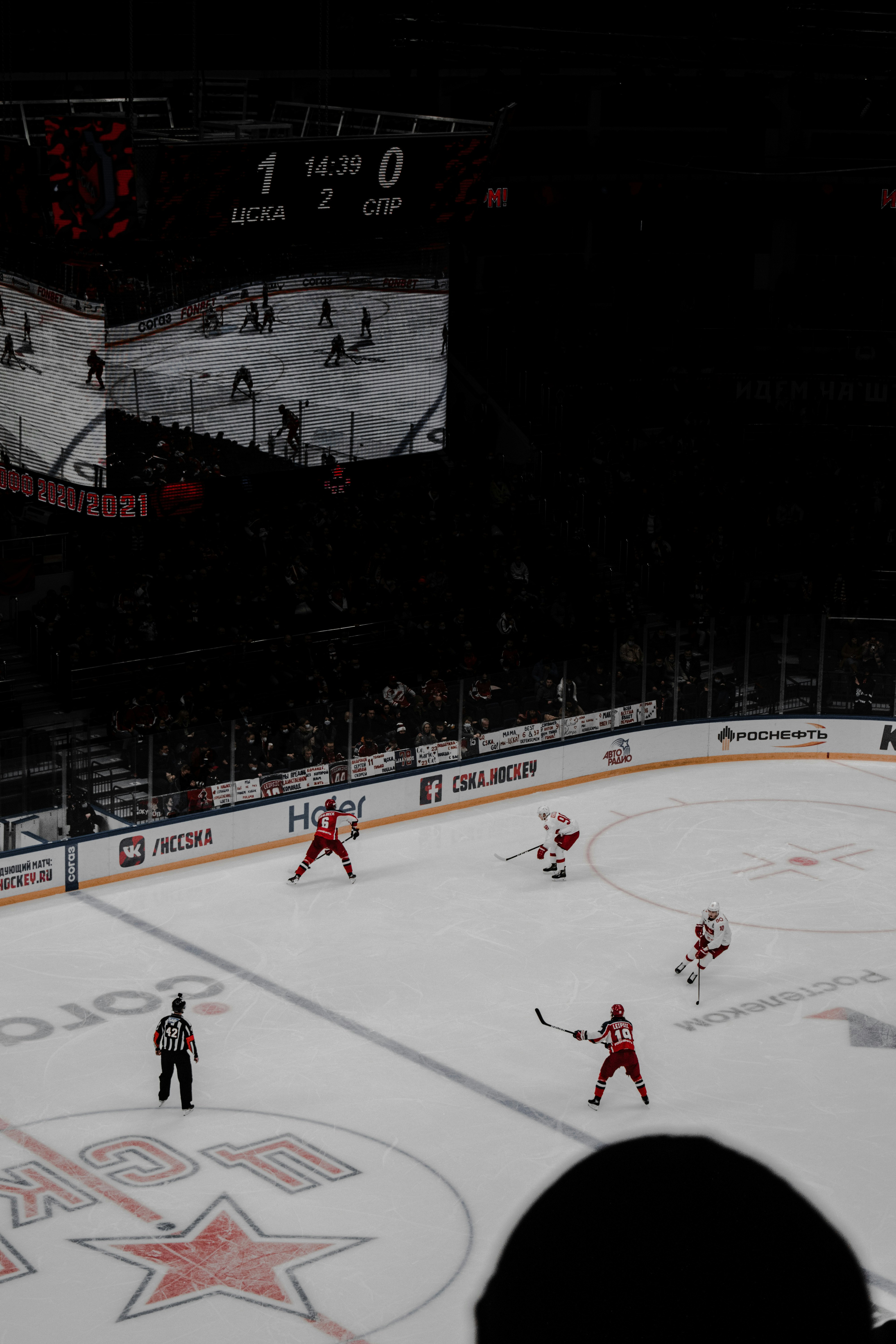 people playing ice hockey during nighttime